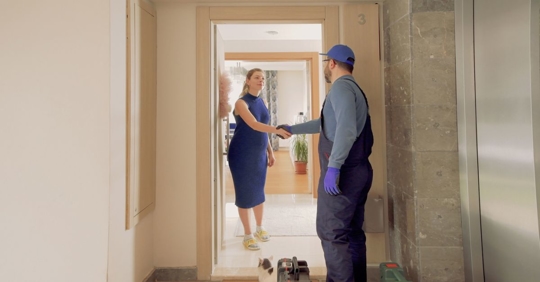 Plumber shaking client's hand