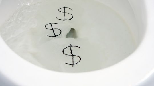 Toilet with dollar signs in the bowl